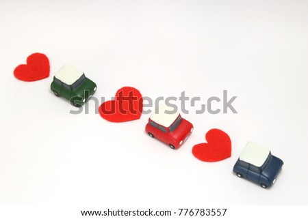 Some red hearts and cars on white background. 
Safe driving concept.