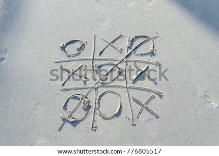 Tic-tac-toe drawn on the beach near the sea as holiday concept background - Vintage tone