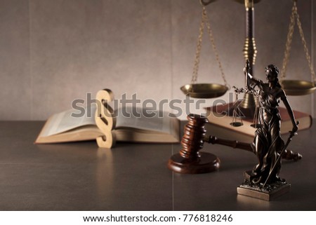 Law and justice concept background. Gavel, scales of justice, books. Gray stone background, place for typography.
