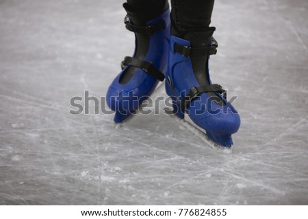 Cropped shot of woman's legs standing on ice rink