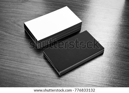 Mockup of white and black business cards at wooden background. Template for branding identity
