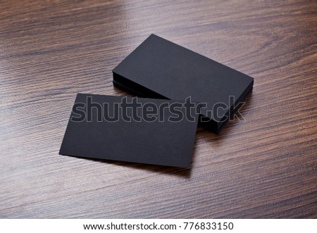 Mockup of black business cards at wooden background. Template for branding identity