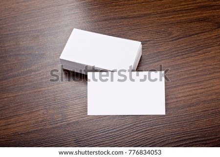 Mockup of white business cards at wooden background. Template for branding identity