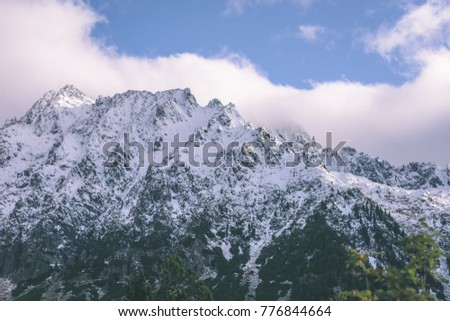 panoramic view of Tatra mountains in Slovakia covered with snow and hiding in mist. high altitude - vintage retro film look