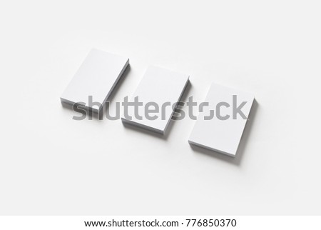 Three blank white business cards stacks on paper background. Template for ID.