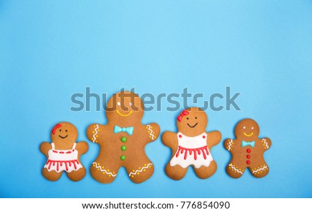 Gingerbread family on the blue background. Christmas and new year concept, copy space for text. Top view.