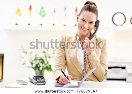 Picture showing happy receptionist working in hotel
