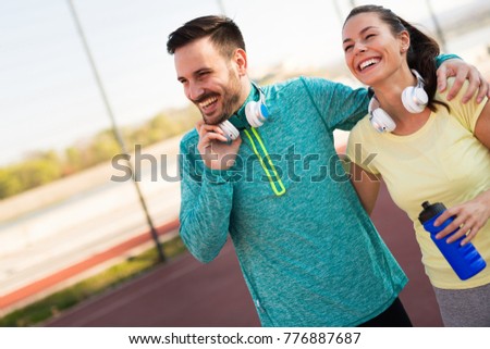 Handsome man and attractive woman talking on court