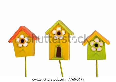 Three colorful bright starling-houses isolated on white background