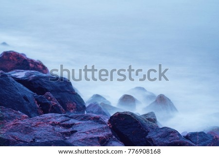 Dreamy natural background with sea shore, rocks and waves. Long exposure