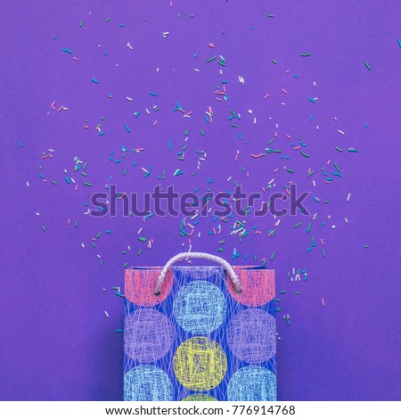 Christmas gift or bag on ultra violet background with confetti. flat lay, top view. minimalist