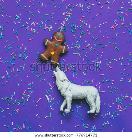 sly fox is holding on the nose the gingerbread man on ultra violet background with confetti.  magical fairy tale