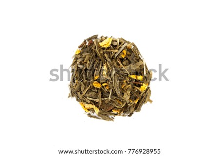Beautiful and delicious dried tea leaves with herbs, flowers, berries, fruits, coconut slices, cocoa and coffee chips. Detailed studio shoot with selective focus and abstract blurred background