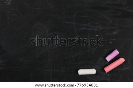 Colorful chalks on chalkboard, blackboard texture