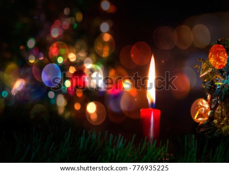 Red Candle on the table in Christmas night with colorful bokeh light effected, Copy space