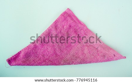 A triangle fold pink towel handkerchief. 