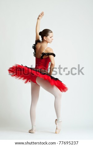 cute, young and beautiful ballet dancer posing over white background