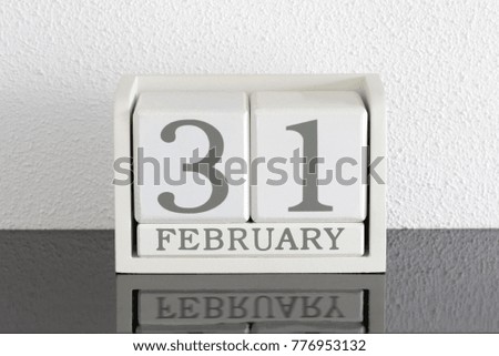White block calendar present date 31 and month February on white wall background - Extra day
