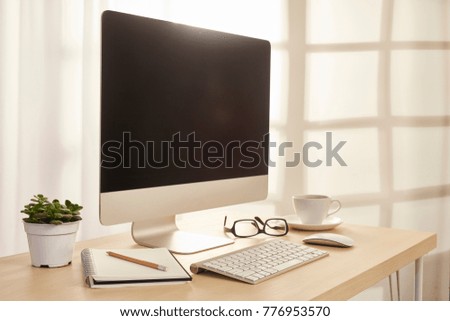 working desk with computer and window background