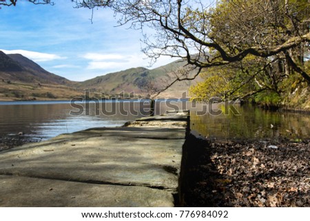 Stone bridge under the trees facing the mountains. Picture taken at Buttermere Lake District and Crummock Water, England