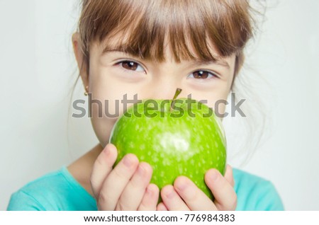 Child and green apple. Selective focus. 