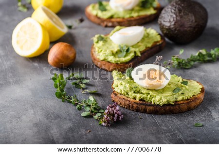 Bio avocado on bread with boiled egg, delish food