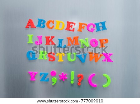 Colorful magnetic letters on refrigerator door. Funny Colorful Comics Kid Font.  Fridge Magnet Style. Letters Set For Text and Design.
