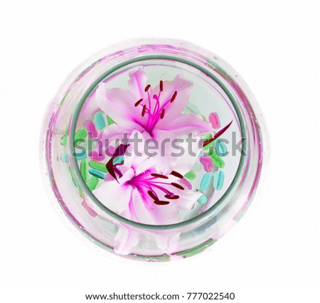 beautiful large flowers of lilies in a glass on a white background. isolate