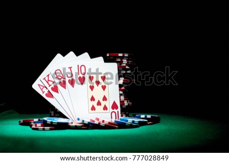 Playing cards, poker chips, and dices on green table