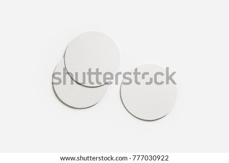 Three blank white beer coasters on paper background. Responsive design mockup. Flat lay. Royalty-Free Stock Photo #777030922