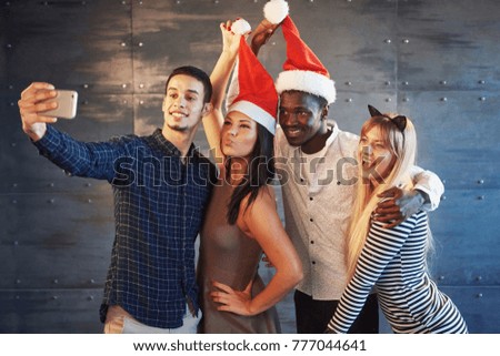 Picture showing group of multiethnic friends celebrating New Year.