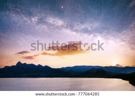 magnificent panorama over the sea. Vibrant night sky with stars and nebula and galaxy. Deep sky astrophoto.