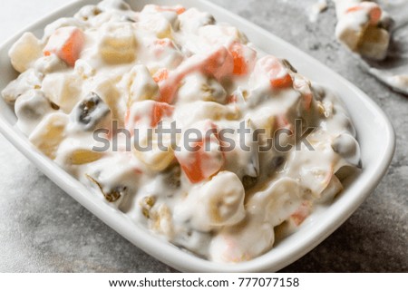 Russian Salad Olivier with beans, potatoes, carrot, yogurt and mayonnaise.