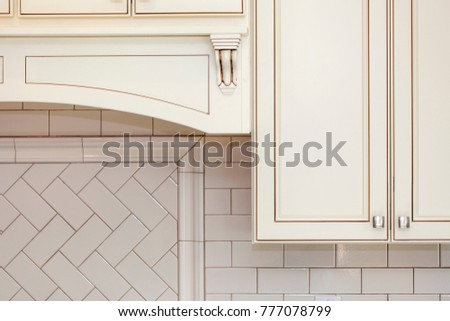 White wall cabinets and subway tile backsplash , vintage style cabinets Royalty-Free Stock Photo #777078799