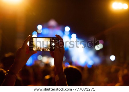 concert party,christmas concert party,dancing in concert newyear party,some body using smartphone record video,lighting effect,selective focus,blurly and flair lighting effect
