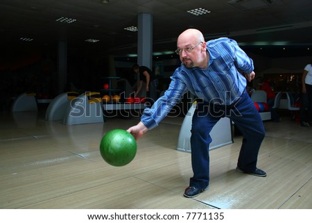 The man, a playing bowling alley