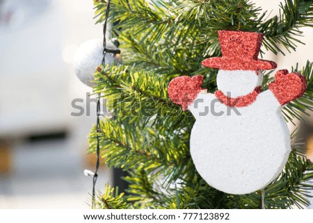 Foam snow man on green pine tree background