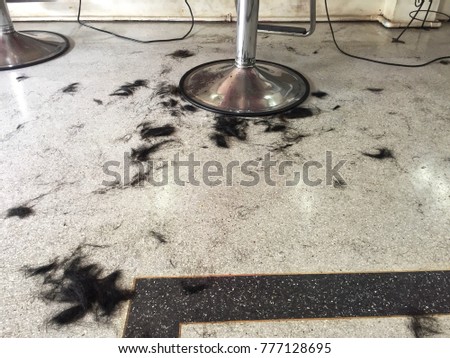 Hairline on the floor in a barber shop.