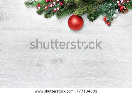 Christmas and New Year's composition. The pine cones, spruce branches on a wooden white background, top view