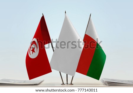 Flags of Tunisia and Madagascar with a white flag in the middle