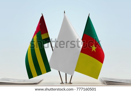 Flags of Togo and Cameroon with a white flag in the middle