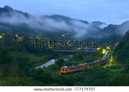 New Taipei City Taiwan's summer, foggy valleys, rustic rural dusk lights, open light trains Panoramic pictures of farmland driving through.