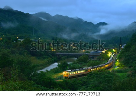 New Taipei City Taiwan's summer, foggy valleys, rustic rural dusk lights, open light trains Panoramic pictures of farmland driving through.