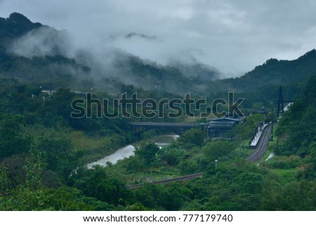 New Taipei City Taiwan's summer, foggy valley, rural simplicity of the evening, the panorama picture of the train passing through the farmland.