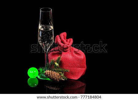 Glass of champagne with gift in the bag and the twig
