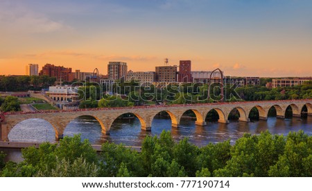 Minneapolis Minnesota at sunset on the Mississippi river,  beautiful stone arch bridge of Minneapolis, Royalty-Free Stock Photo #777190714