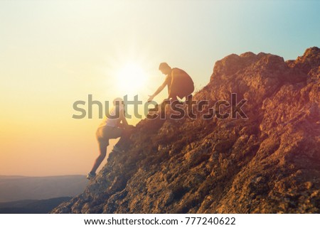 People helping each other hike up Royalty-Free Stock Photo #777240622