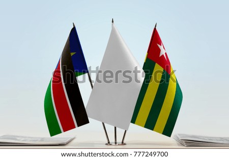 Flags of South Sudan and Togo with a white flag in the middle