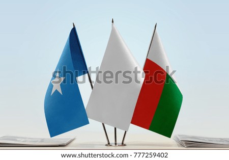 Flags of Somalia and Madagascar with a white flag in the middle