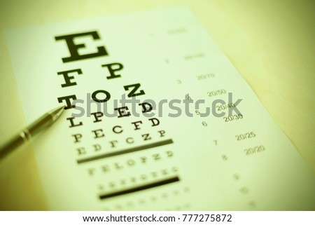 Pen pointing to letter in eyesight check table. Driver health certificate examination Royalty-Free Stock Photo #777275872